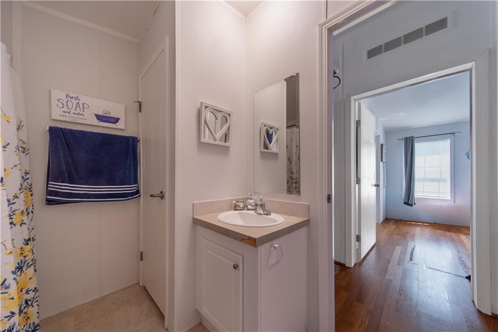 Bathroom with vanity and wood finished floors