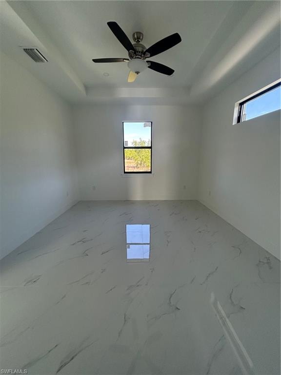 Unfurnished room featuring a raised ceiling