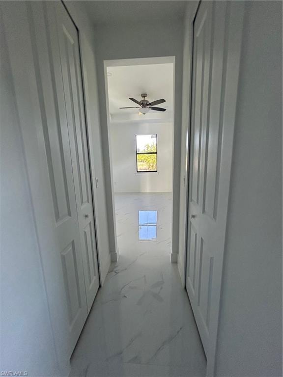 Hall featuring marble finish floors and baseboards
