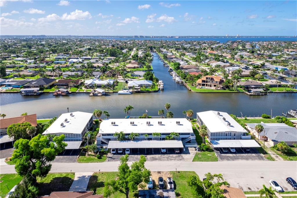 Aerial view of residential area featuring a large body of water