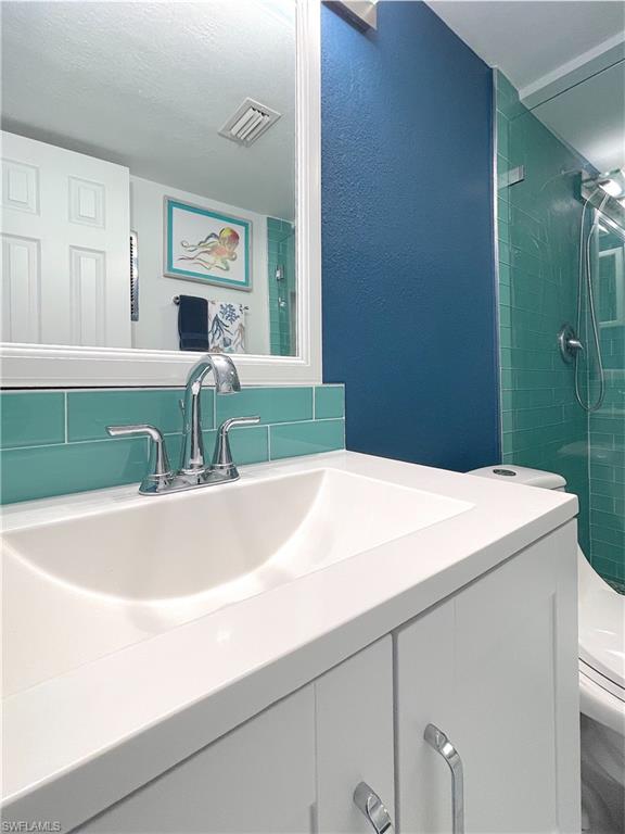 Full bathroom featuring vanity and a tile shower