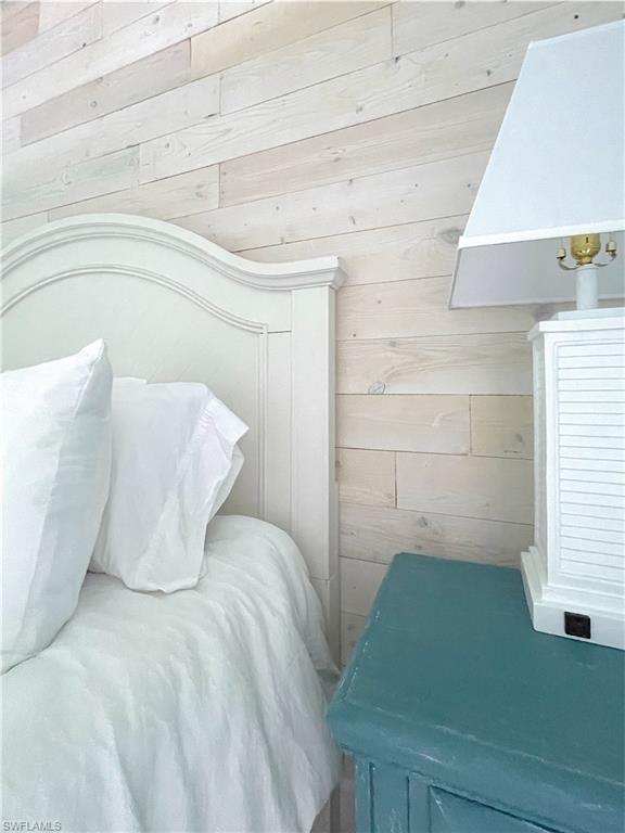 Bedroom featuring wood walls