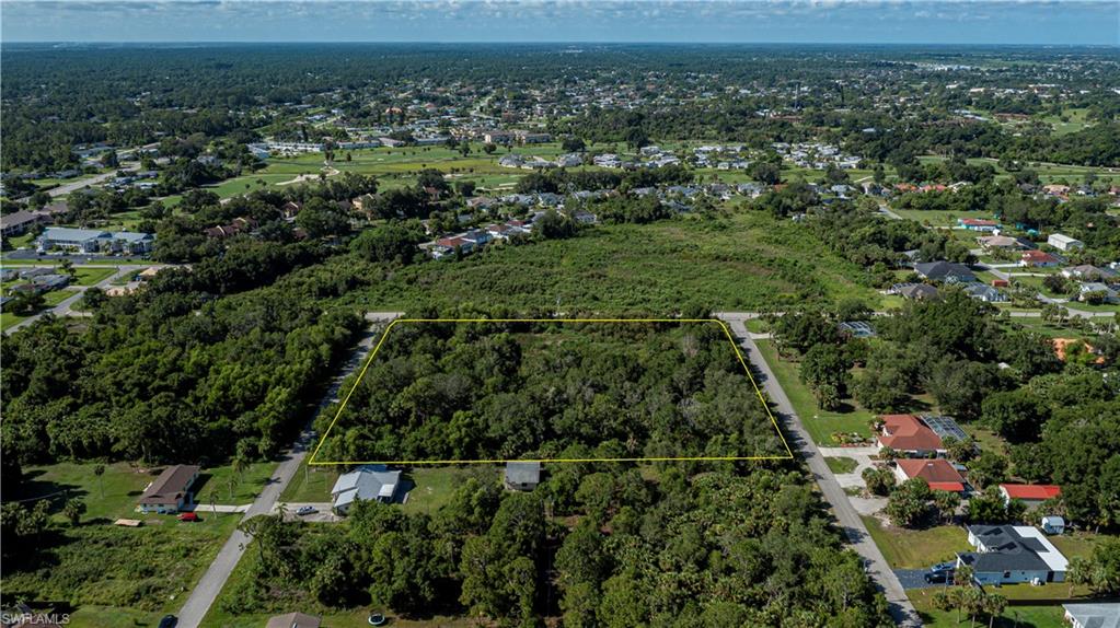 View of property location featuring property boundaries highlighted and  wooded area