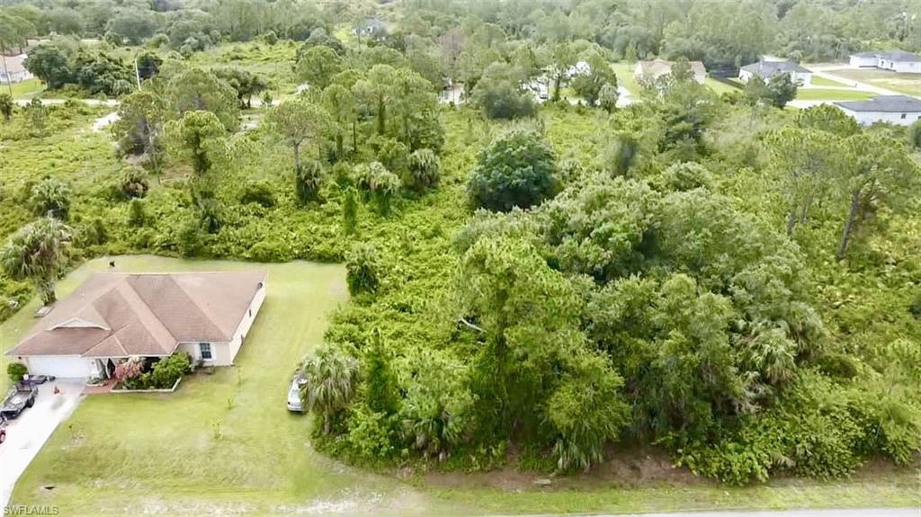 View of subject property with a heavily wooded area