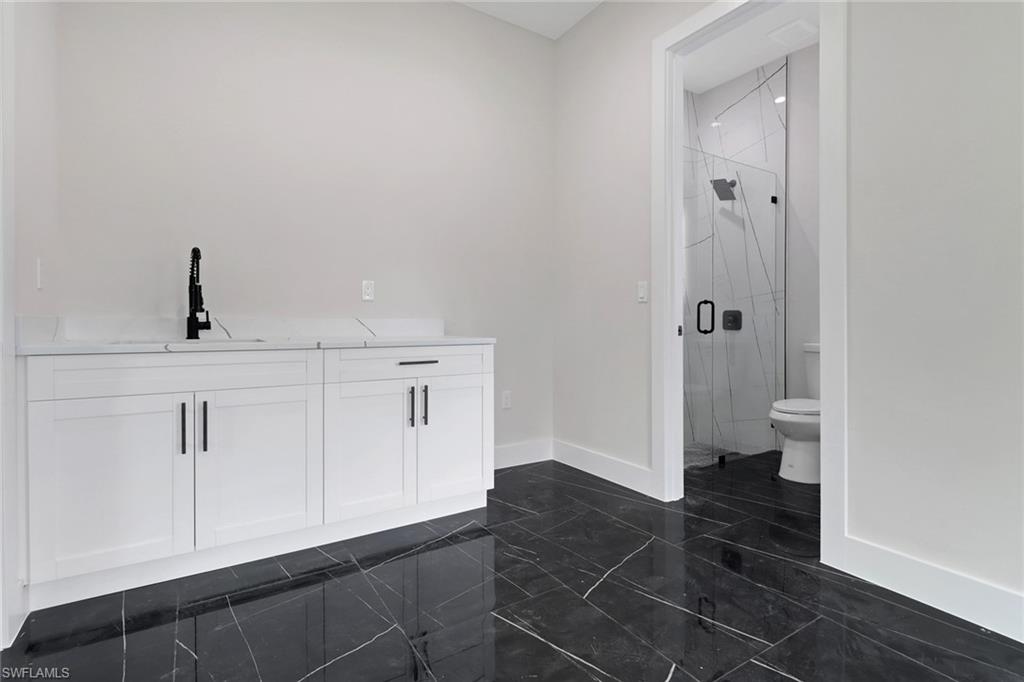 Bonus Room / Media Room / Home Office with wetbar area and access to private bathroom