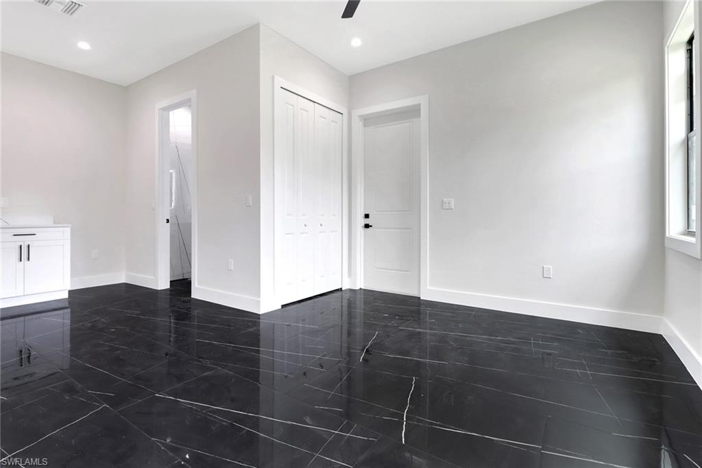 Bonus room / Media Room / Home Office featuring access door to the outside, tile floors, wet bar, ceiling fan, and recessed lighting