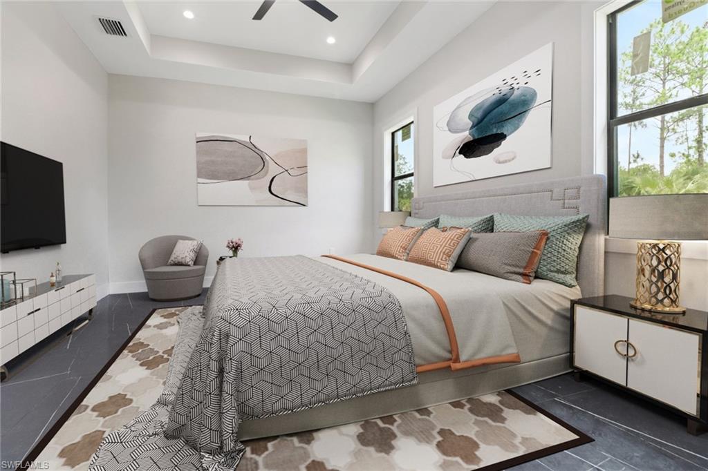 Bedroom with a raised ceiling, dark tile patterned flooring, ceiling fan, and recessed lighting