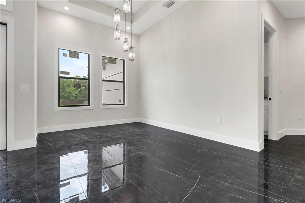 Dining room with tile flooring and modern lighting