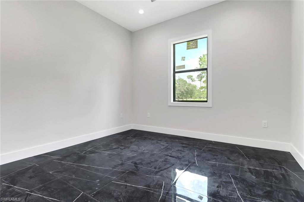 Guest bedroom with tile flooring and recessed lighting