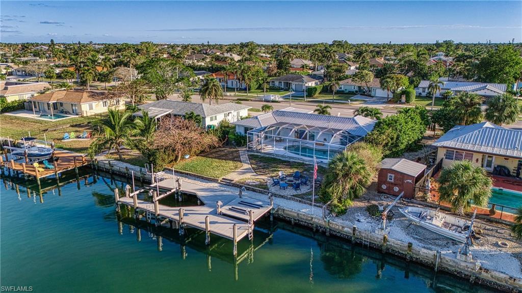 Aerial perspective of suburban area with a nearby body of water