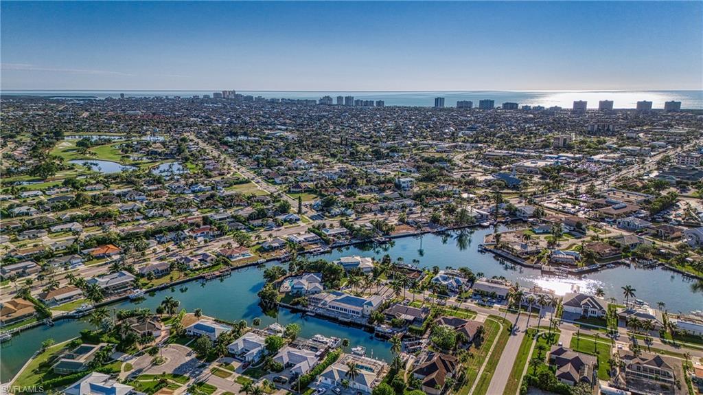 Aerial overview of property's location with a large body of water and nearby suburban area