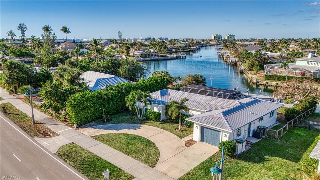 Aerial perspective of suburban area featuring a nearby body of water