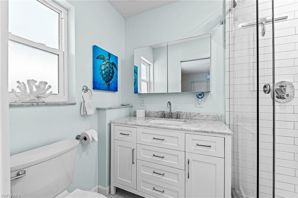 Bathroom with vanity and a tile shower
