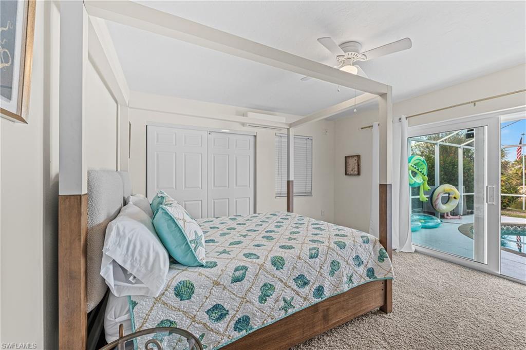 Carpeted bedroom featuring access to outside, a closet, and a ceiling fan