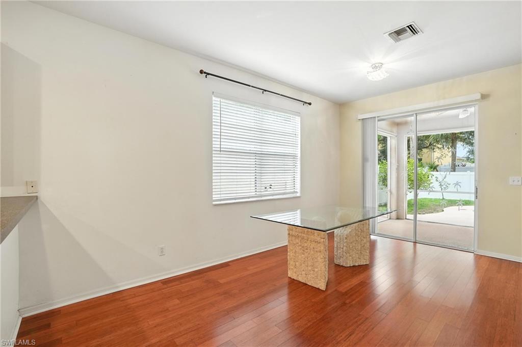 Unfurnished dining area with wood-type flooring and baseboards