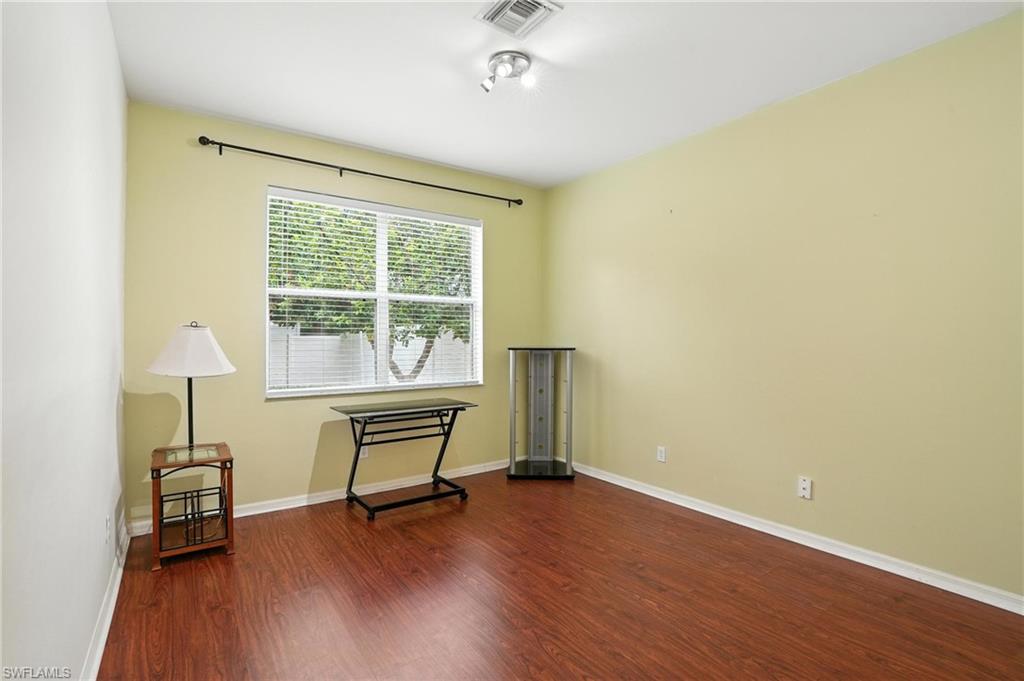 Empty bedroom featuring wood finished floors and baseboards