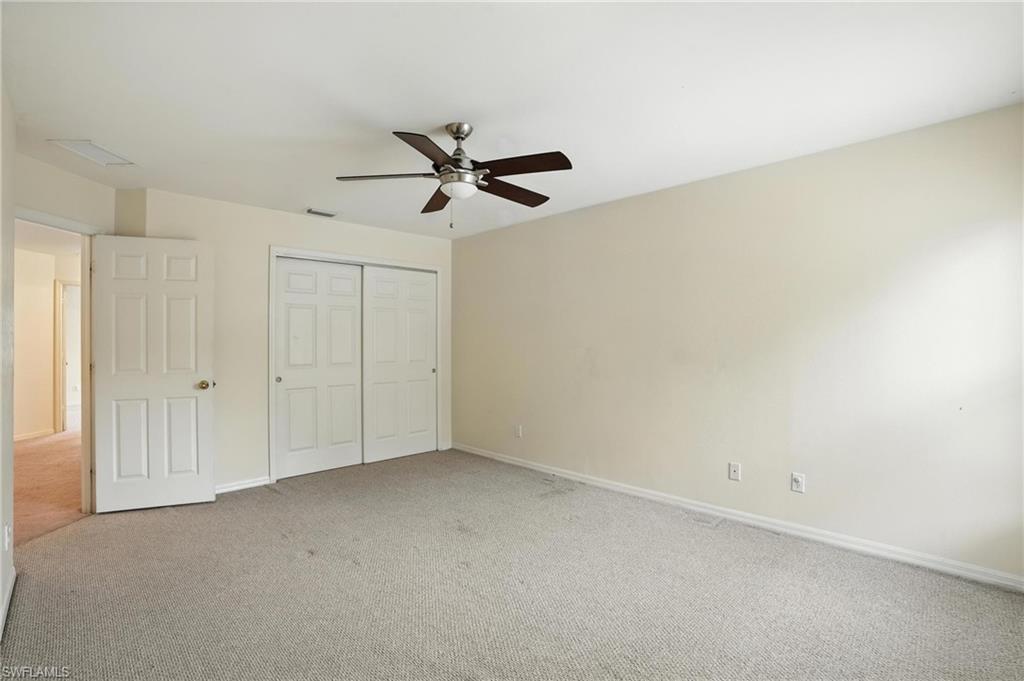 Unfurnished bedroom with carpet, a closet, and ceiling fan