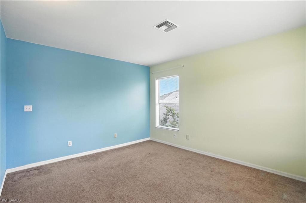 Spare room featuring carpet floors and baseboards
