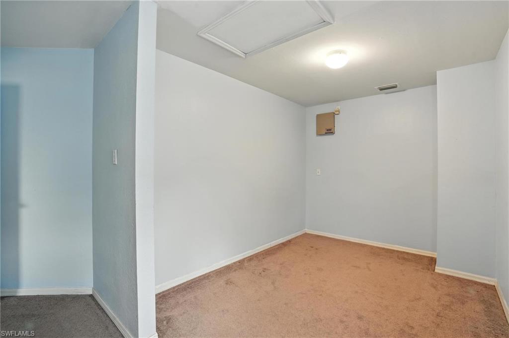 Spare room with carpet flooring and attic access