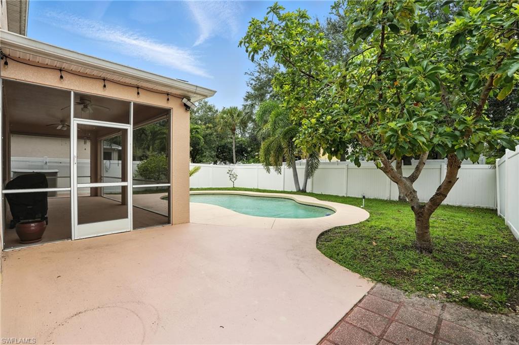 View of swimming pool with a fenced backyard, a patio area, ceiling fan, and a sunroom