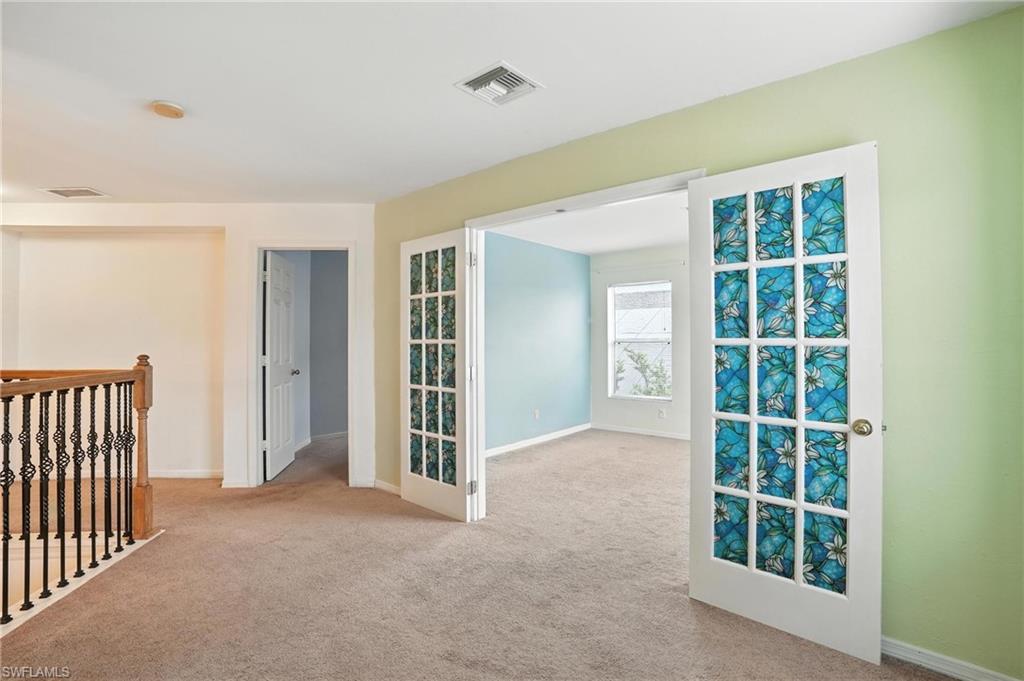 Unfurnished room with carpet and baseboards