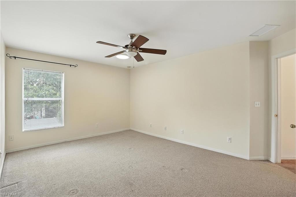 Spare room with light carpet and ceiling fan