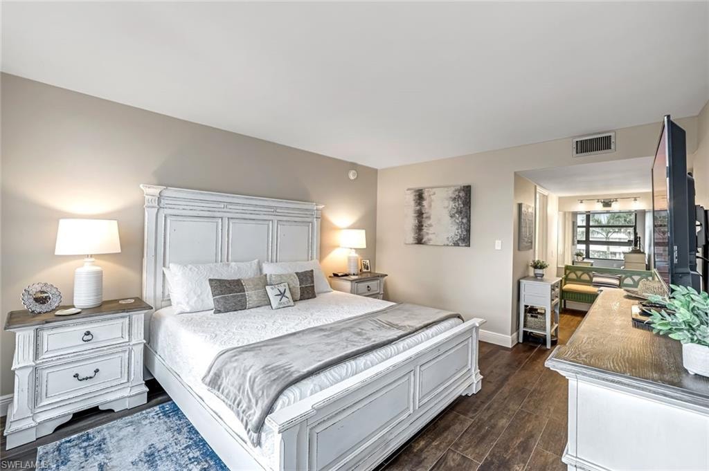Bedroom featuring baseboards and dark wood-type flooring