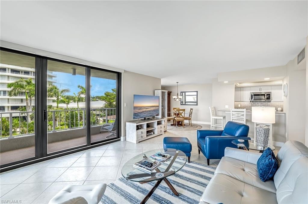 Living room with plenty of natural light and light tile patterned floors