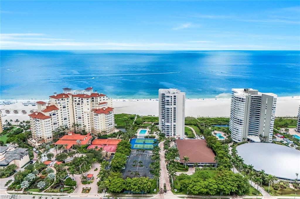 Aerial view of expansive beach and apartment complex / building