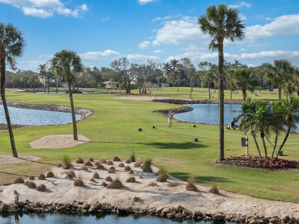 View of property's community with a water view, golf course view, and a yard