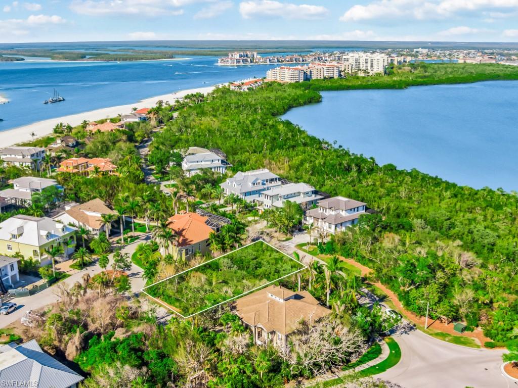 Aerial view of property's location with a nearby body of water and property boundaries highlighted