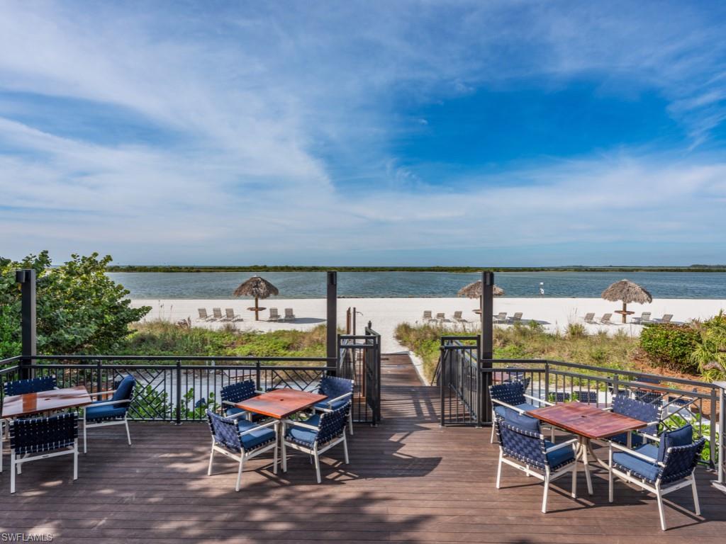 Wooden deck featuring outdoor dining area and a water view