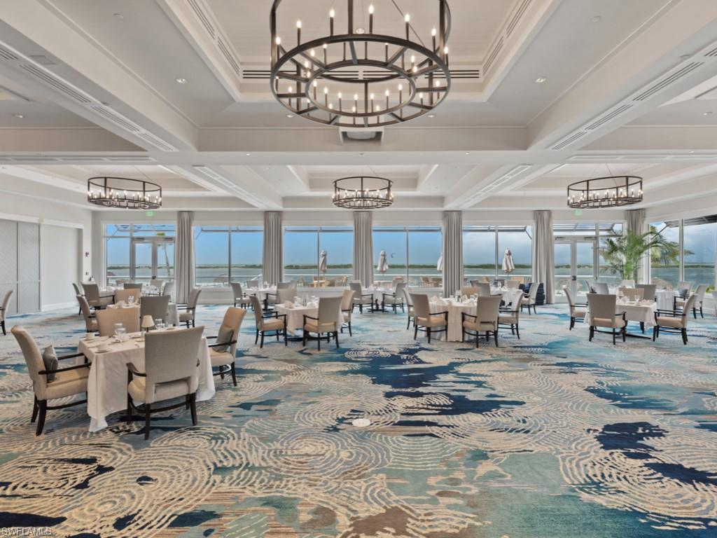 Common area with coffered ceiling, crown molding, beam ceiling, and a water view