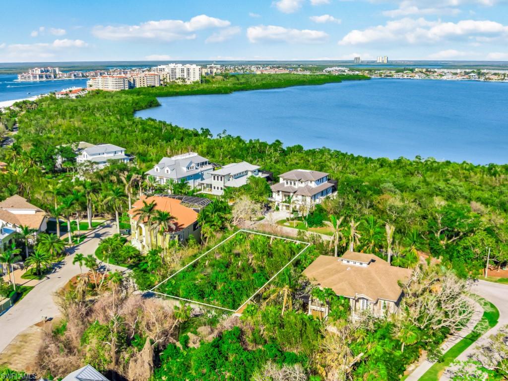 Aerial view of property's location with a nearby body of water and property boundaries highlighted
