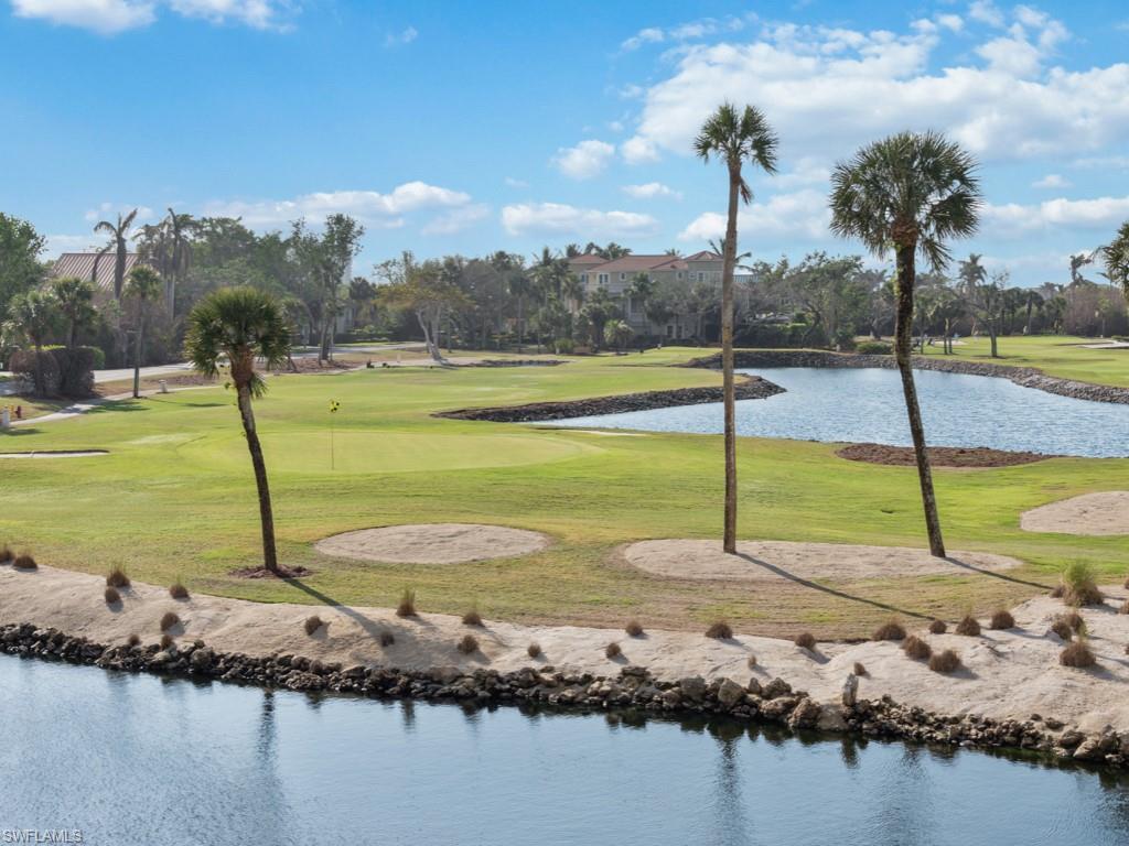 View of community featuring a water view, a yard, and view of golf course