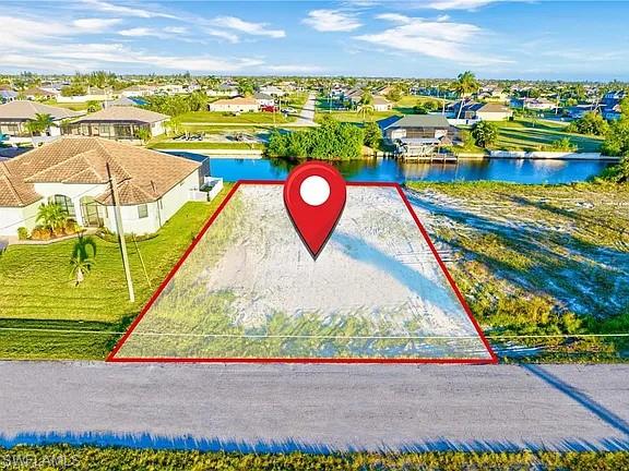 Aerial perspective of suburban area with a nearby body of water