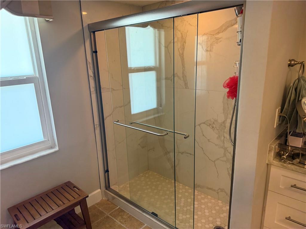 Bathroom featuring a marble finish shower