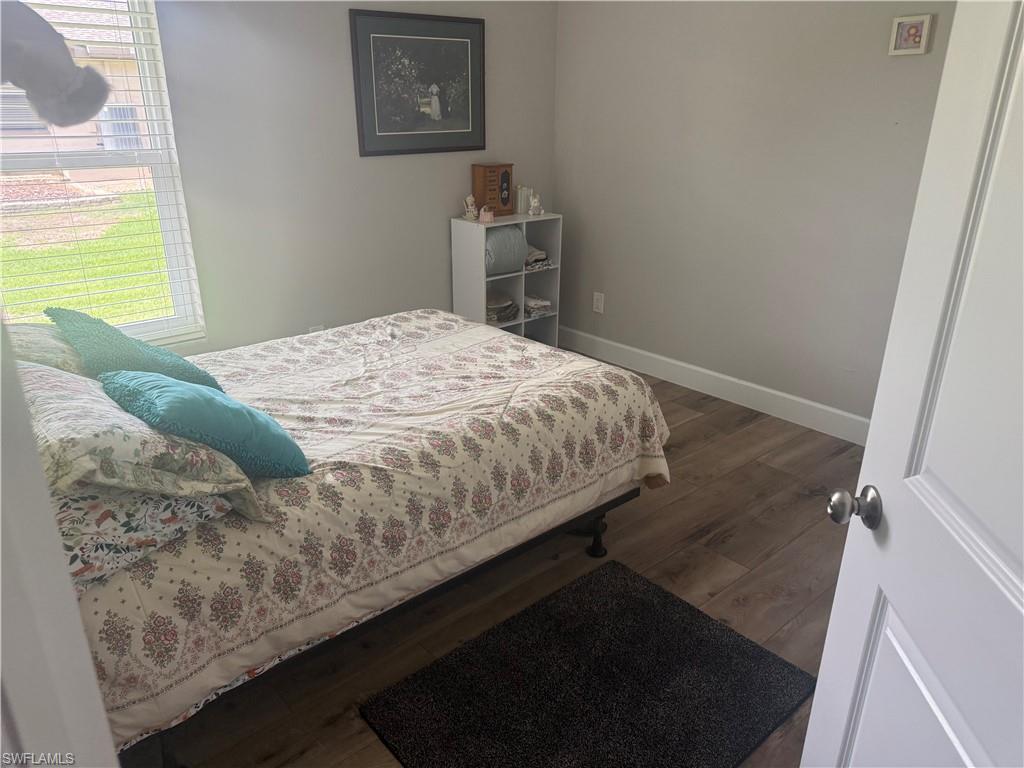 Bedroom featuring wood finished floors and baseboards