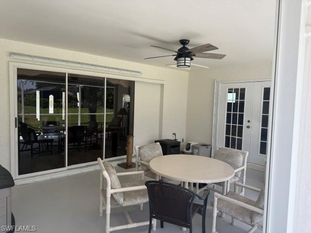 View of patio with french doors and a ceiling fan