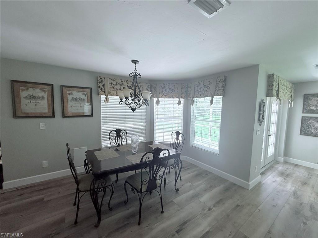 Dining space featuring a chandelier and light wood-type flooring