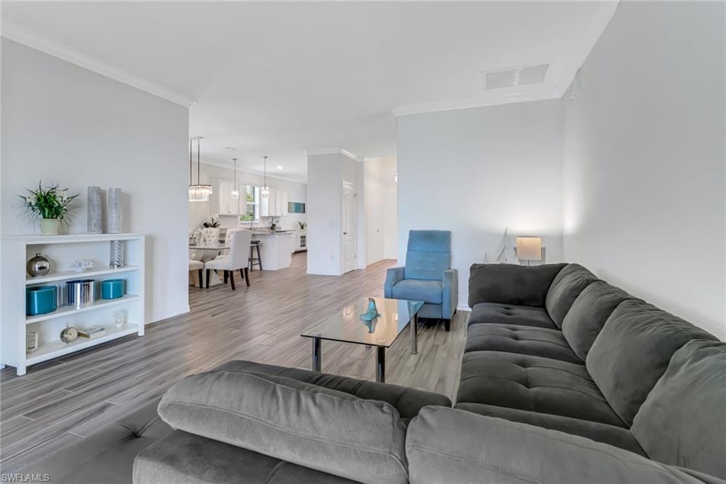Living room featuring crown molding and wood finished floors