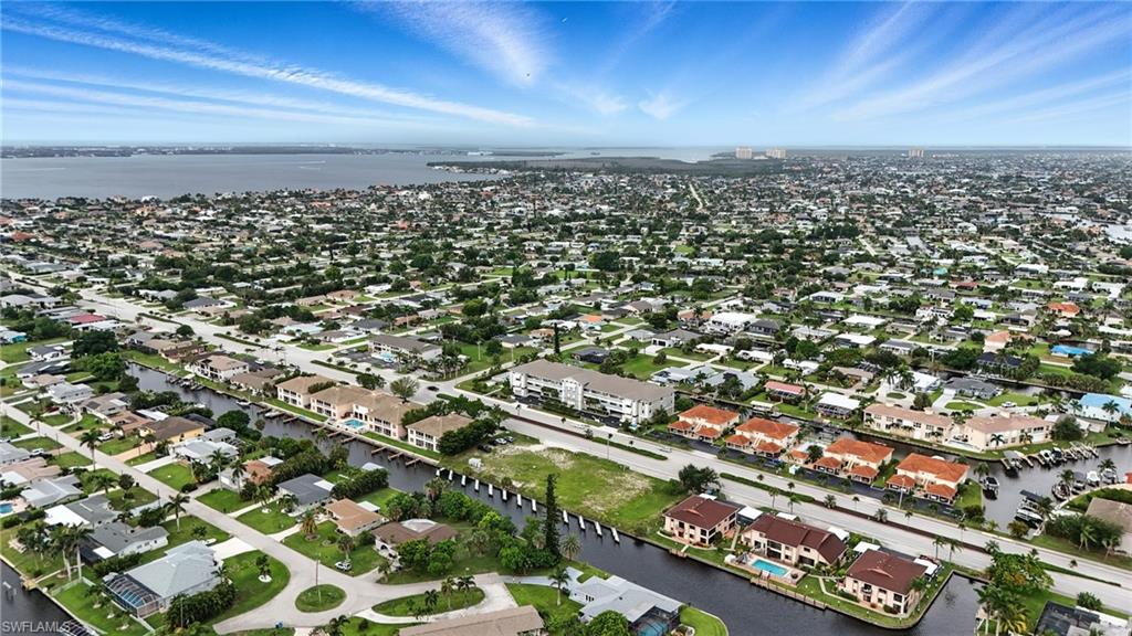 Aerial overview of property's location with a nearby body of water and nearby suburban area