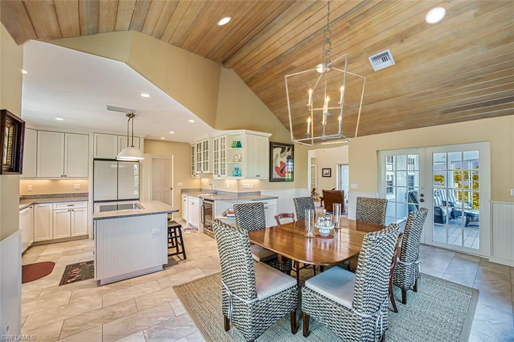 Dining Space And Kitchen With Access To Enclosed Lanai