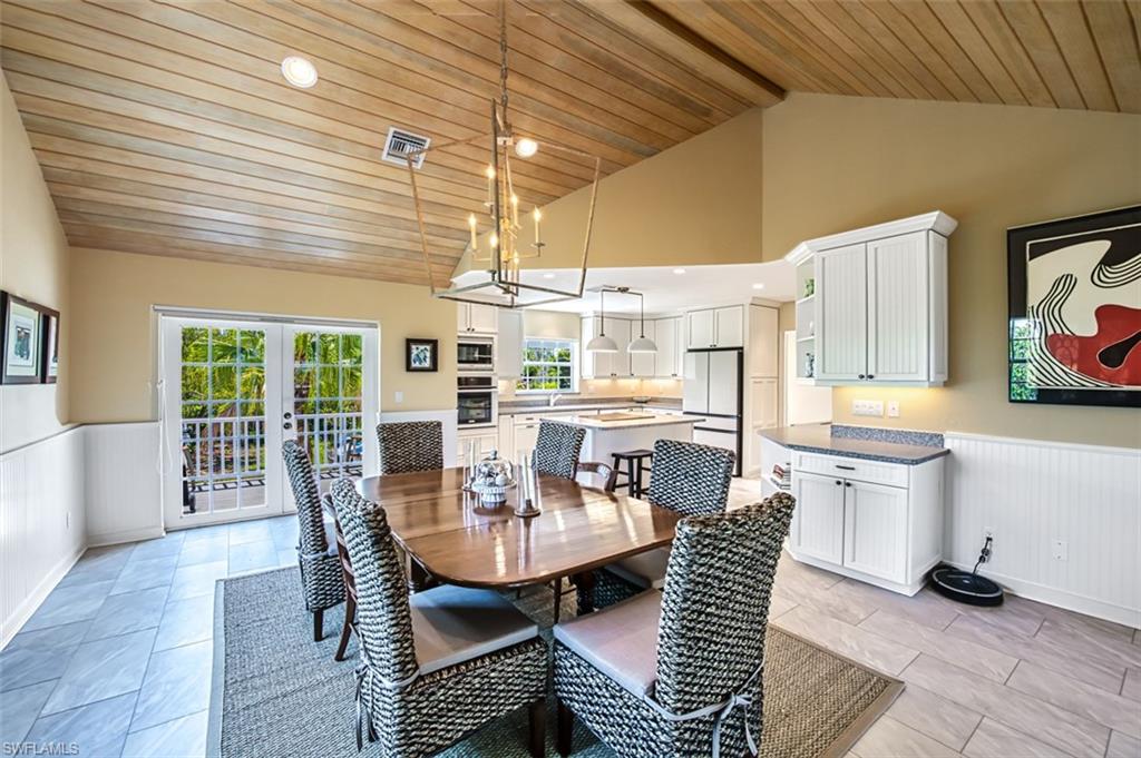 Dining Area Looking Into Kitchen With Access To Open Air Patio