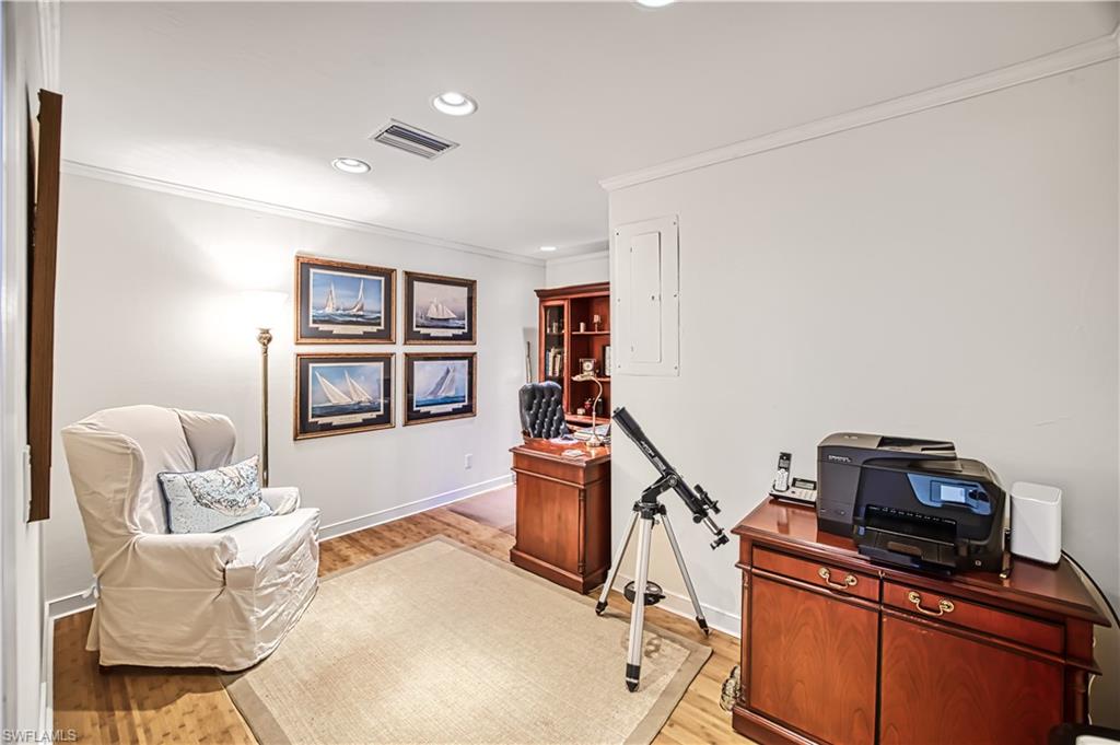 Home office featuring crown molding, recessed lighting, and light wood-type flooring