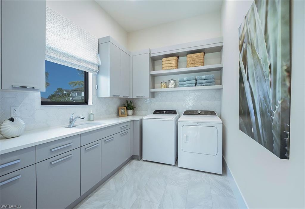 Washroom featuring washer and dryer and cabinet space