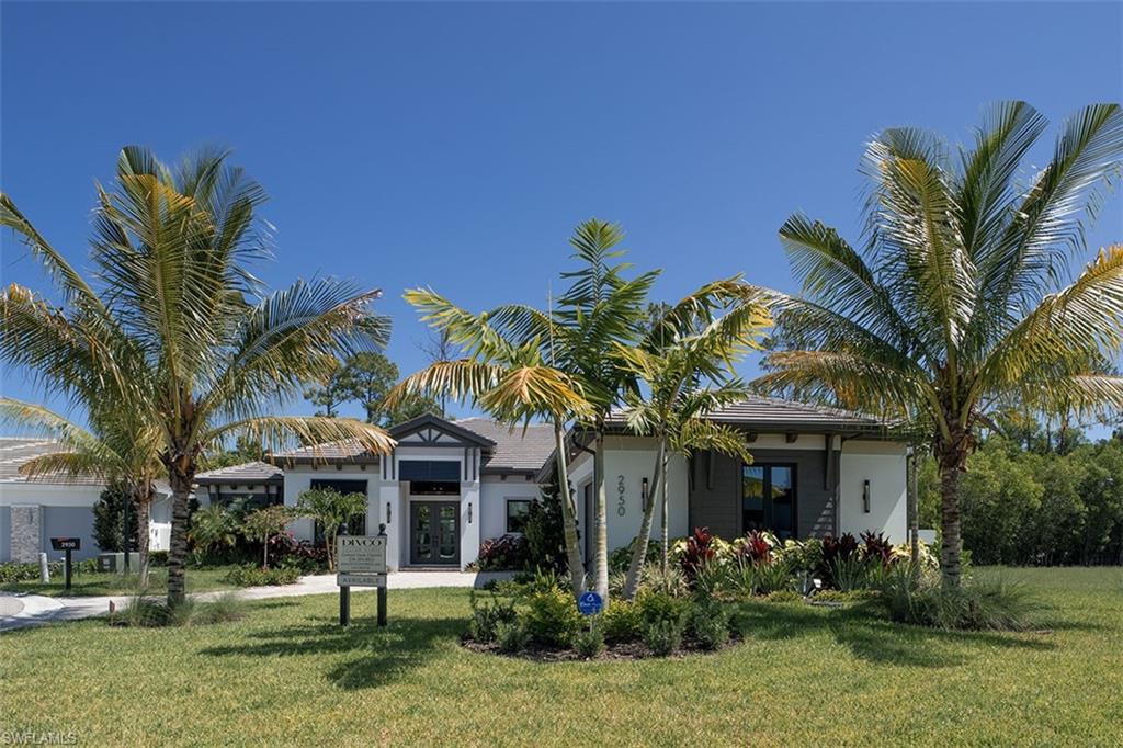 View of front of property featuring a front lawn and stucco siding