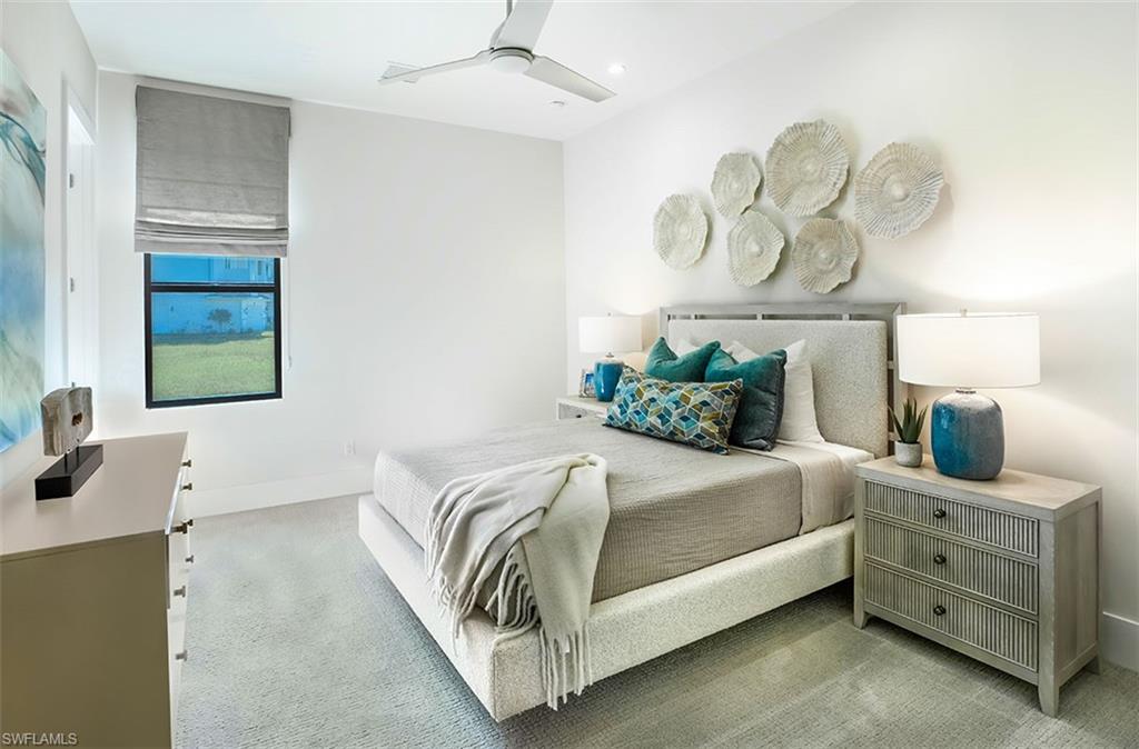Bedroom with light carpet and a ceiling fan