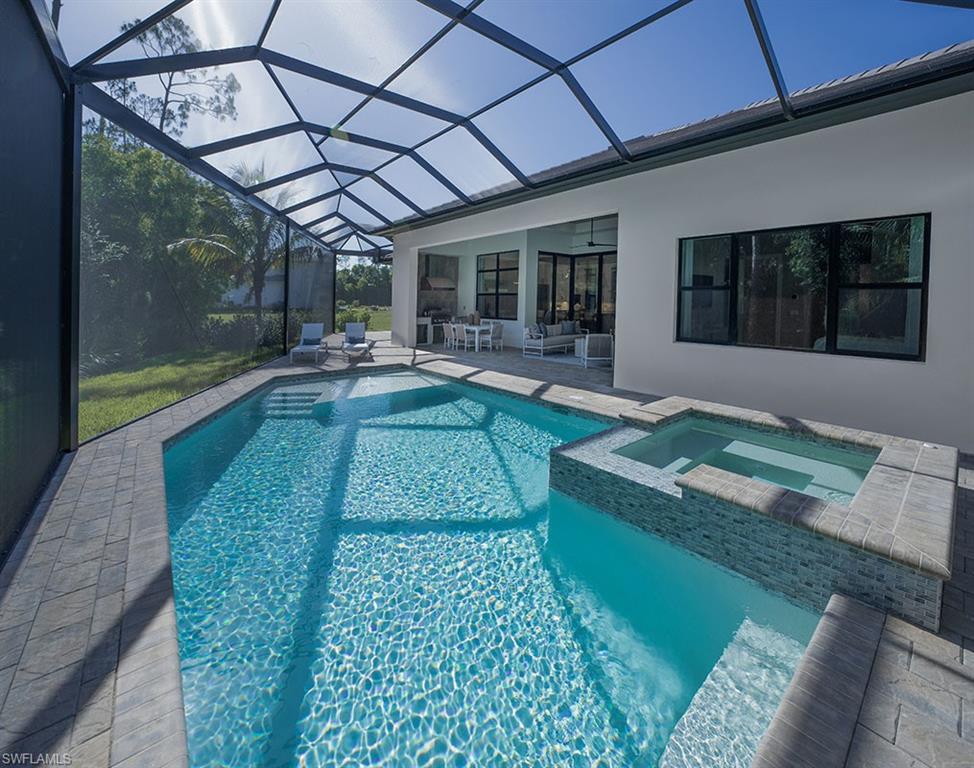 View of swimming pool featuring a patio, a sunroom, a pool with connected hot tub, a lanai, and ceiling fan