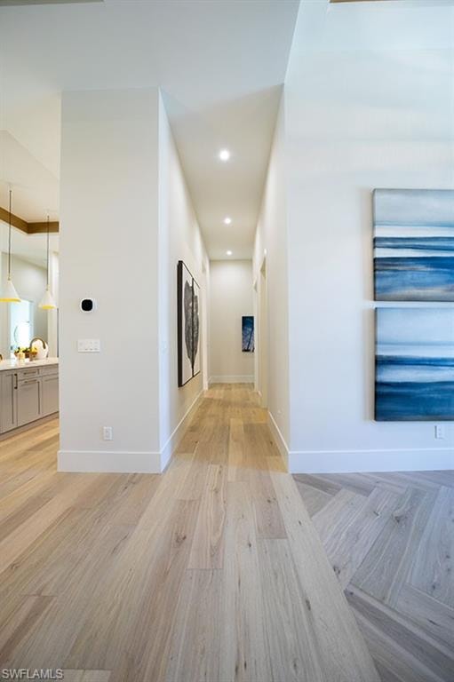 Hall featuring light wood-type flooring and recessed lighting